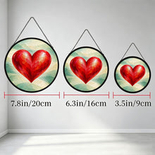 Load image into Gallery viewer, Three Follow Your Heart red heart glass suncatchers hanging side by side to illustrate different sizes.