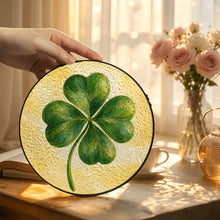 Load image into Gallery viewer, Lucky Charm glass suncatcher featuring a green four-leaf clover with beautifully layered brushwork against a soft golden-yellow background.
