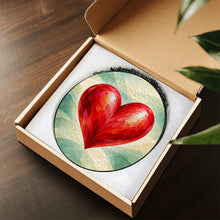 Load image into Gallery viewer, Follow Your Heart red heart glass suncatcher displayed in an open gift box, showcasing its colorful decorative window hanging design.
