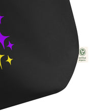 Load image into Gallery viewer, Close-up of the bottom corner of the Astro Glow oversized black organic cotton tote bag, highlighting its sturdy construction, premium fabric, and organic cotton label.