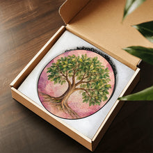 Carica l'immagine nel visualizzatore di Gallery, Rooted in Abundance Tree of Life stained glass-style suncatcher presented in an open gift box, showcasing its botanical green and pink design.
