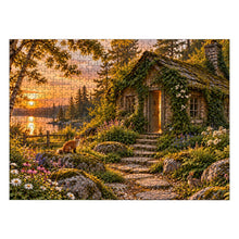 Загрузить изображение в средство просмотра галереи, THE OPEN DOOR 500 piece wooden jigsaw puzzle featuring an abandoned ivy covered cottage with a glowing cracked door, woodland path, sunset lake, fox, rabbit, and wildflowers.
