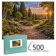 Загрузить изображение в средство просмотра галереи, TURNING POINT 500 piece wooden jigsaw puzzle featuring a KNOWN and UNKNOWN signpost at a forked forest path with wildflowers and sunset mountains.

