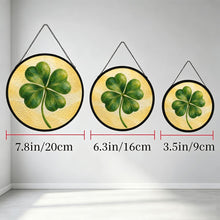 Carica l'immagine nel visualizzatore di Gallery, Lucky Charm glass suncatcher featuring a green four-leaf clover with beautifully layered brushwork against a soft golden-yellow background.
