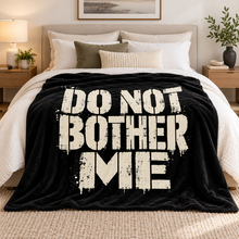 Загрузить изображение в средство просмотра галереи, Do Not Bother Me black flannel throw blanket with distressed off-white lettering displayed on a bed with white bedding in a modern bedroom. Little Yellow Bungalow.
