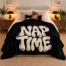 Загрузить изображение в средство просмотра галереи, Woman sleeping peacefully under the Nap Time black flannel throw blanket with distressed off-white typography, surrounded by cozy pillows in a modern bedroom. Little Yellow Bungalow.
