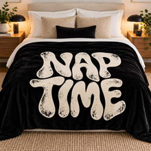 Загрузить изображение в средство просмотра галереи, Nap Time black flannel throw blanket featuring oversized distressed off-white lettering, displayed on a neatly styled bed in a cozy modern bedroom. Little Yellow Bungalow.

