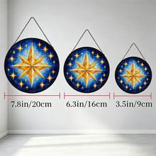 Загрузить изображение в средство просмотра галереи, Three Written in the Stars glass suncatchers hanging side by side in different sizes, each featuring golden stars on a painterly blue background.

