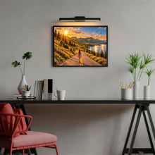 Load image into Gallery viewer, The Road Ahead 500 piece wooden jigsaw puzzle featuring a woman walking down a scenic mountain road with wildflowers, deer, soaring birds, a lake, pine trees, mountains, and a golden sunset.
