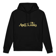 Ladda upp bild till gallerivisning, Front view of black ABRACADABRA organic cotton side pocket hoodie with buttery yellow magic wand, stars, and decorative lettering.
